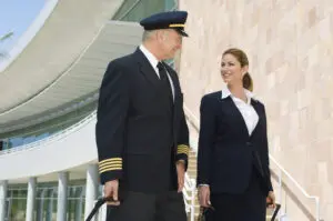 Pilot and flight attendant walking outside building